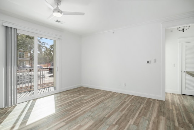 unfurnished room with ceiling fan, ornamental molding, and wood-type flooring