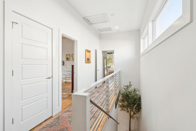 corridor with hardwood / wood-style flooring