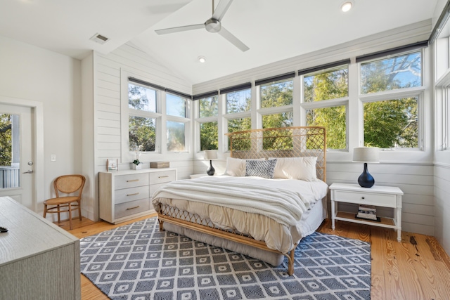 bedroom featuring hardwood / wood-style floors, vaulted ceiling, and ceiling fan