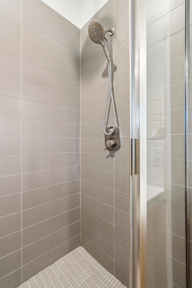 bathroom with a tile shower