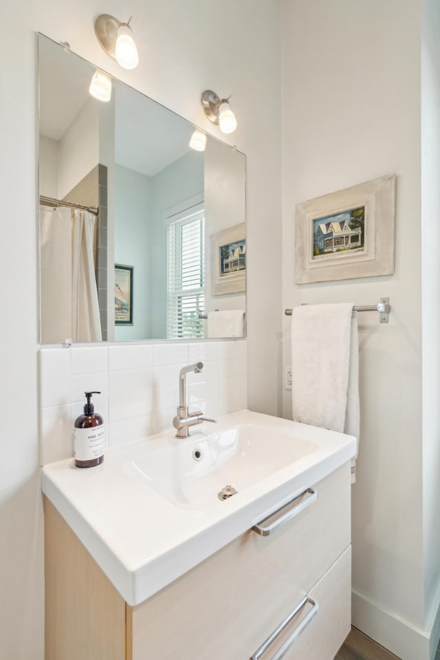 bathroom featuring vanity and decorative backsplash