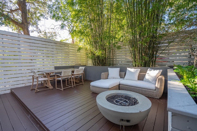 wooden terrace with an outdoor fire pit