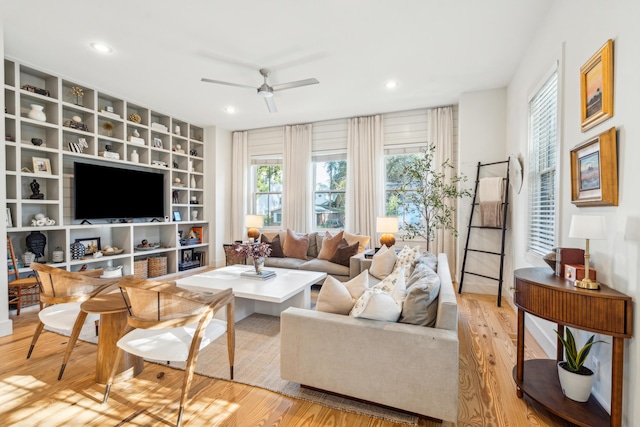 living room featuring ceiling fan and light hardwood / wood-style flooring