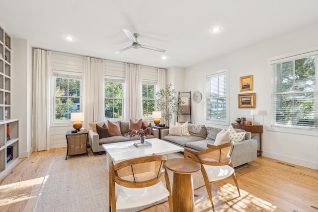 living room with ceiling fan, a healthy amount of sunlight, and light hardwood / wood-style flooring