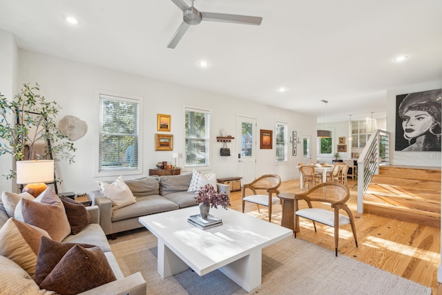 living room featuring light hardwood / wood-style floors and ceiling fan