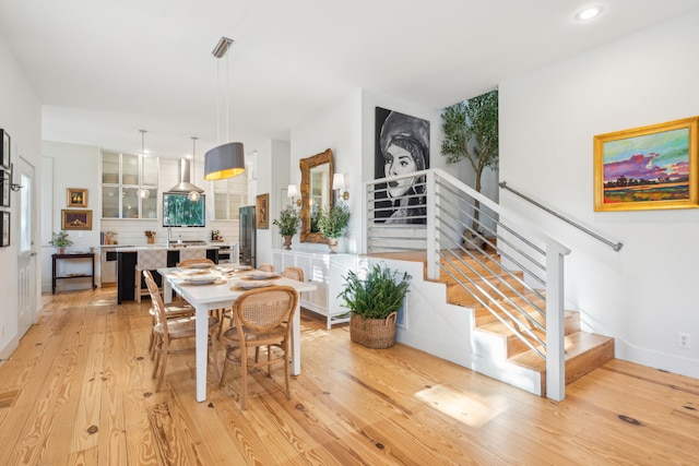 dining space with light hardwood / wood-style flooring