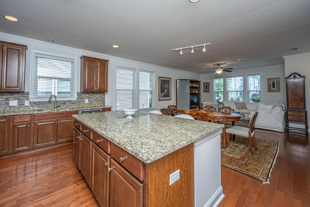 1607 Roustabout Way, Charleston, SC 29414 - kitchen with ornamental molding, a kitchen island, decorative backsplash, wood finished floors, and open floor plan