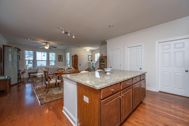 1607 Roustabout Way, Charleston, SC 29414 - kitchen with crown molding, brown cabinetry, dark wood-type flooring, light stone countertops, and open floor plan