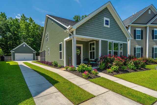 1607 Roustabout Way, Charleston, SC 29414 - view of front facade with a garage, an outdoor structure, a front lawn, and covered porch