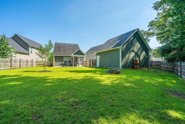 1607 Roustabout Way, Charleston, SC 29414 - back of house featuring a sunroom, an outdoor fire pit, and a fenced backyard