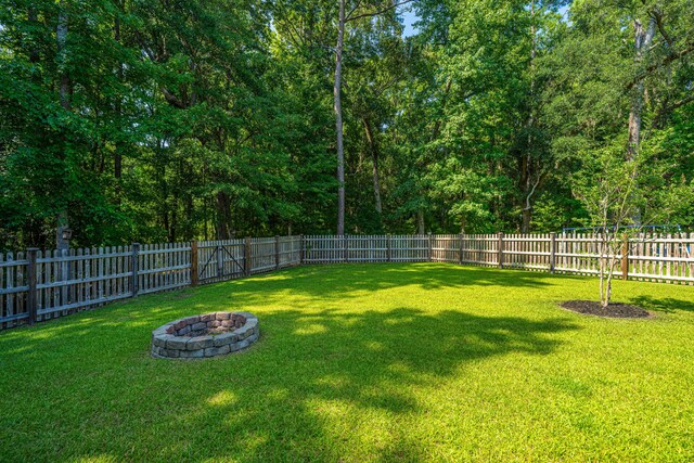 1607 Roustabout Way, Charleston, SC 29414 - fenced backyard featuring an outdoor fire pit