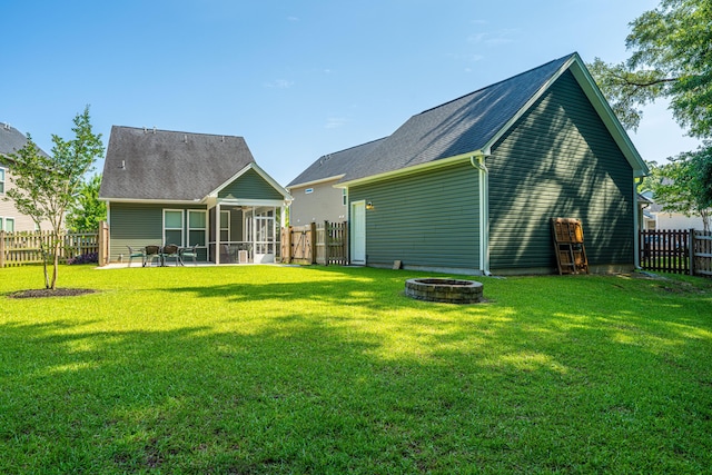 1607 Roustabout Way, Charleston, SC 29414 - rear view of house with a sunroom, a fire pit, a fenced backyard, and a patio