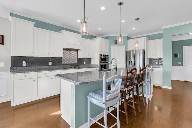 kitchen with dark wood-type flooring, white cabinets, and stainless steel appliances