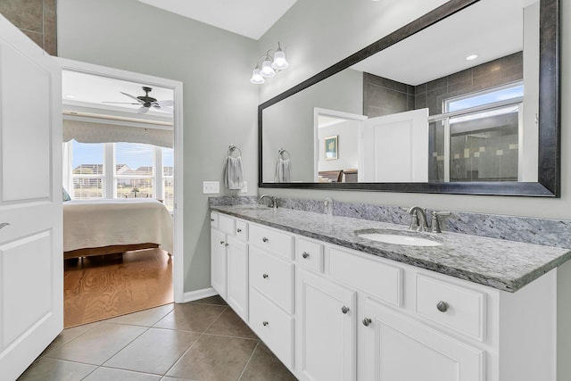 full bathroom with tile patterned flooring, double vanity, a ceiling fan, and a sink