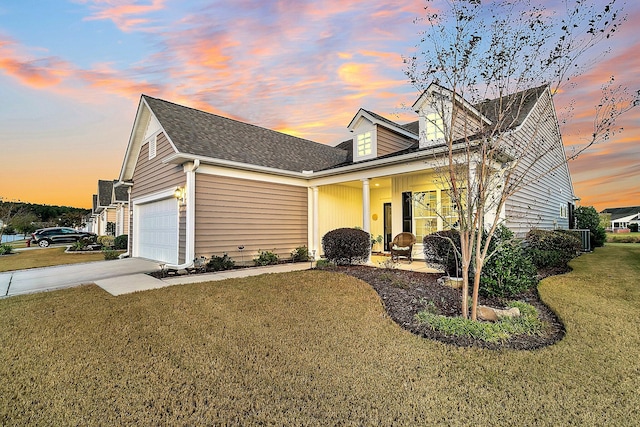 view of front facade with a garage, concrete driveway, and a front lawn