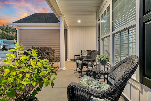 patio terrace at dusk featuring covered porch