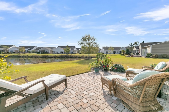 view of patio / terrace with a water view and a residential view