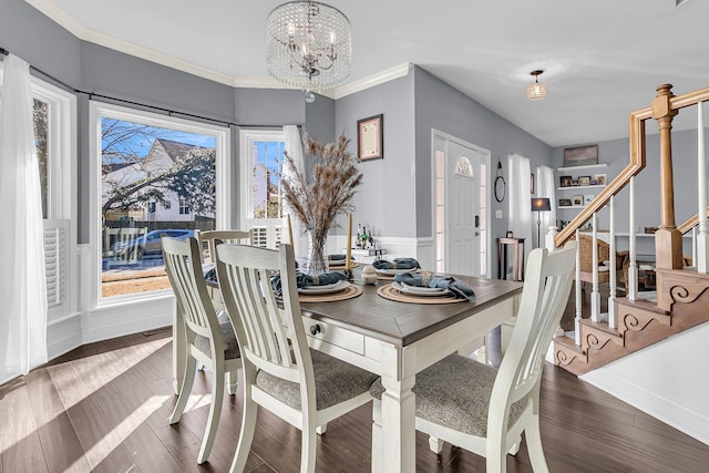 dining room with built in shelves, dark hardwood / wood-style floors, ornamental molding, and an inviting chandelier