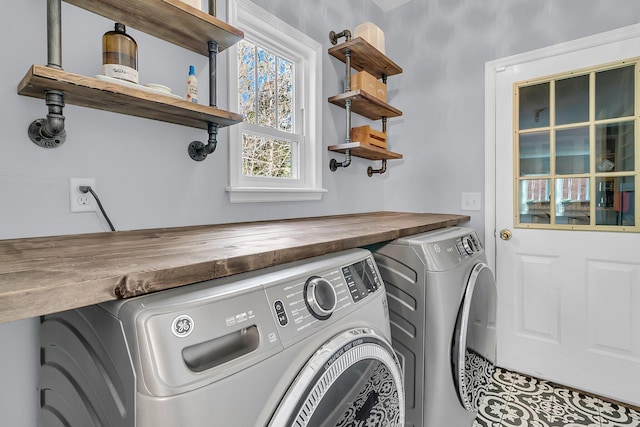 laundry room featuring a healthy amount of sunlight and washing machine and dryer