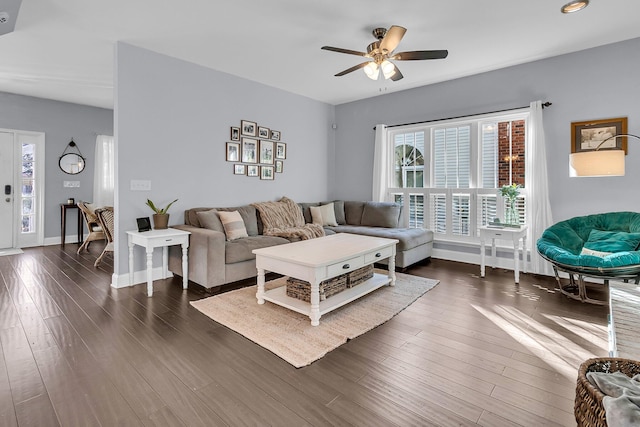 living room with dark hardwood / wood-style floors and ceiling fan