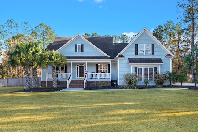 view of front of home with covered porch and a front lawn