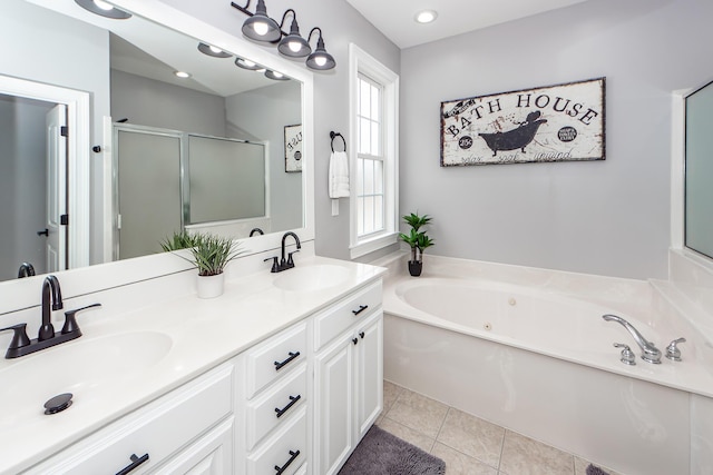 bathroom with a stall shower, a sink, a bath, and tile patterned floors