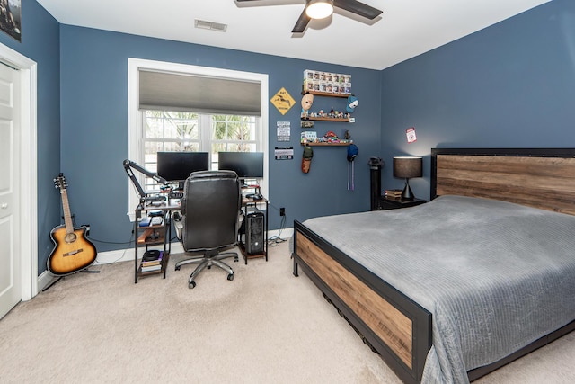 carpeted bedroom with baseboards, visible vents, and a ceiling fan