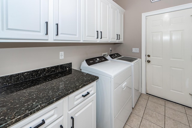 laundry room featuring cabinet space, washing machine and clothes dryer, and light tile patterned floors