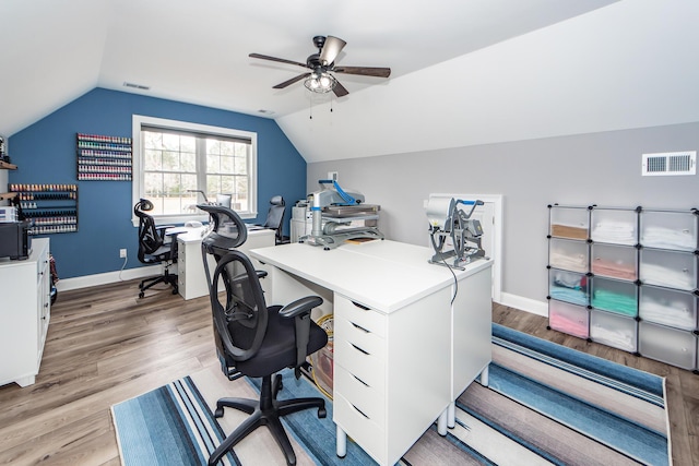 home office with lofted ceiling, light wood finished floors, and visible vents