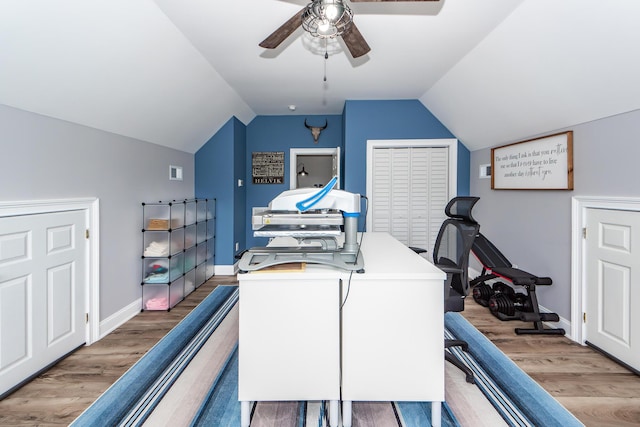 office area with lofted ceiling, light wood-type flooring, a ceiling fan, and baseboards