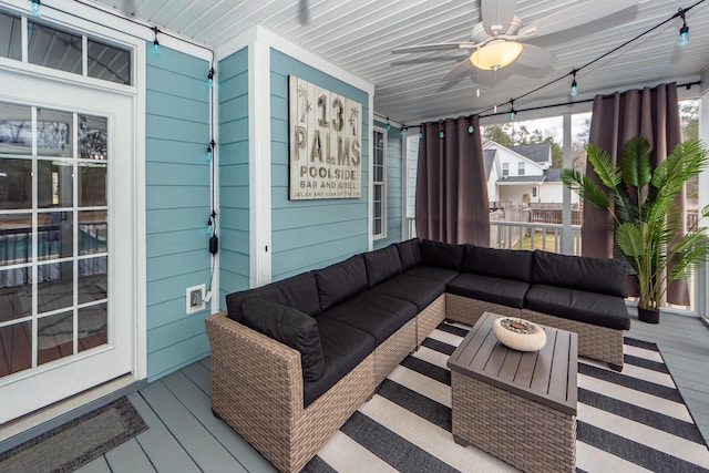 sunroom / solarium featuring ceiling fan