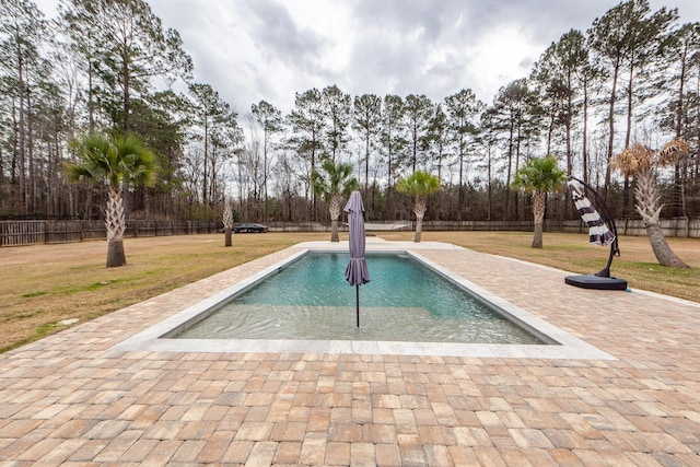 view of swimming pool featuring a fenced in pool, fence, a patio, and a yard