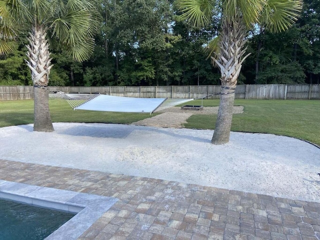 view of home's community featuring a yard and fence