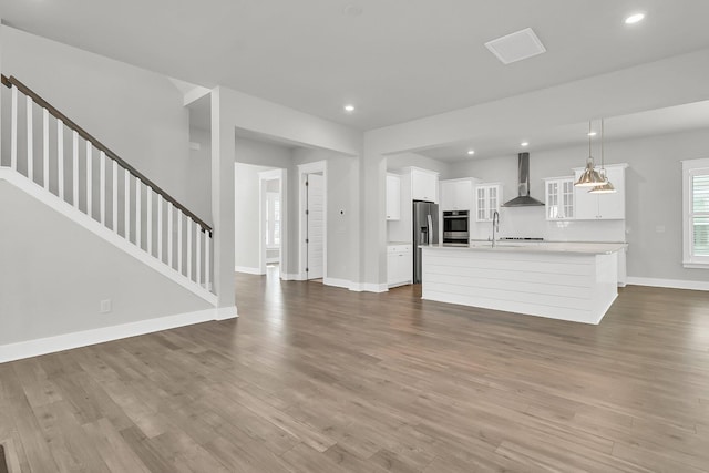 unfurnished living room with sink and wood-type flooring