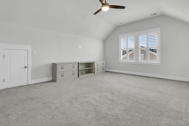 additional living space featuring ceiling fan, light colored carpet, and vaulted ceiling
