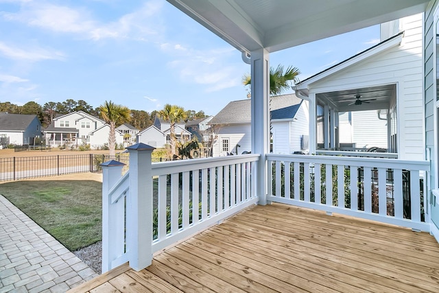 wooden deck with ceiling fan and a yard