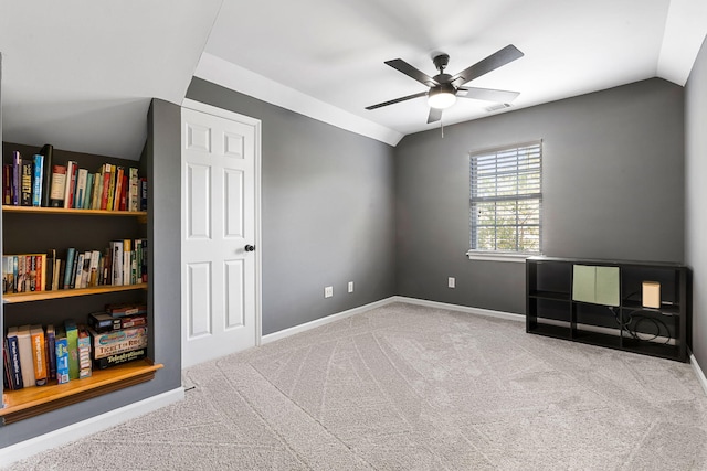 interior space with light colored carpet, ceiling fan, and vaulted ceiling