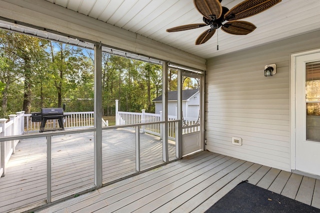 unfurnished sunroom with ceiling fan