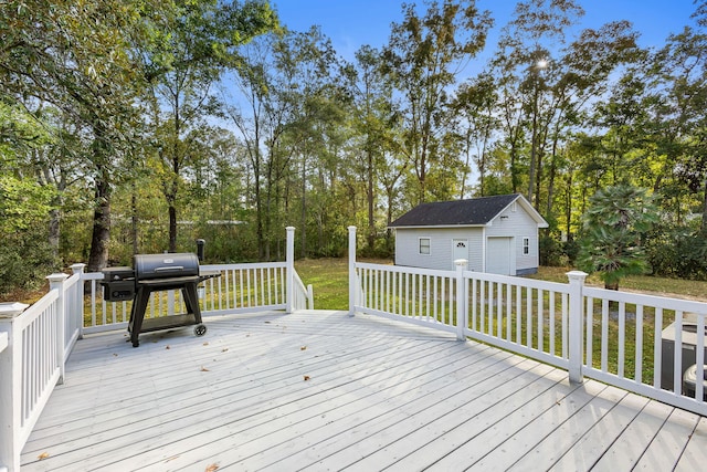 wooden terrace with a grill, an outdoor structure, and a garage