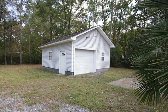 garage featuring a lawn