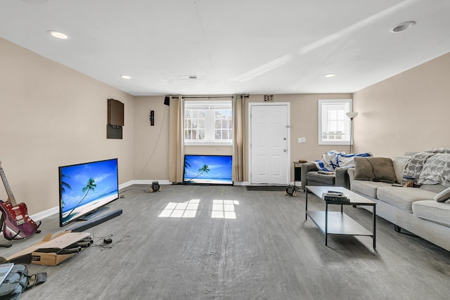 living room with hardwood / wood-style flooring and a healthy amount of sunlight