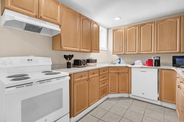 kitchen featuring light tile patterned flooring, white appliances, and sink