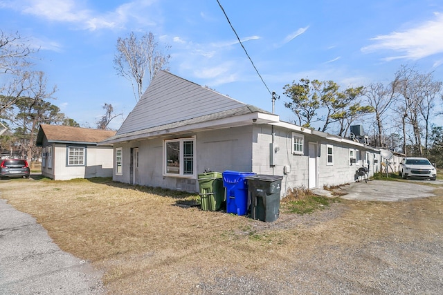 view of property exterior with a lawn