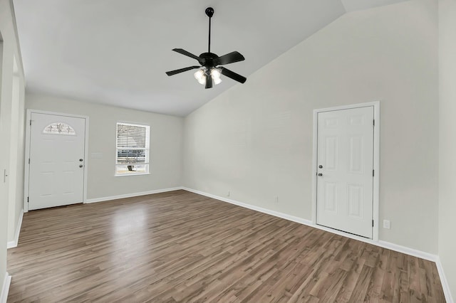 interior space with high vaulted ceiling, wood finished floors, a ceiling fan, and baseboards