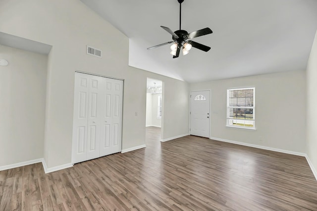 interior space featuring baseboards, visible vents, ceiling fan, and wood finished floors