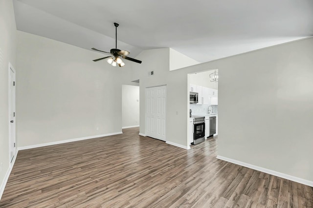 unfurnished living room with visible vents, baseboards, wood finished floors, vaulted ceiling, and ceiling fan with notable chandelier