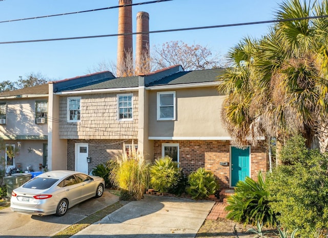 multi unit property featuring brick siding and stucco siding