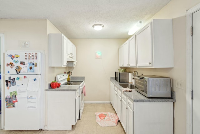 kitchen featuring under cabinet range hood, white appliances, a sink, white cabinets, and light countertops