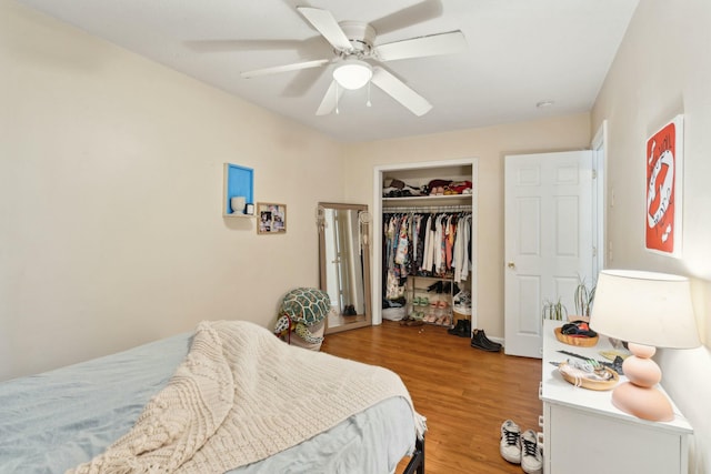 bedroom featuring ceiling fan, a closet, and wood finished floors