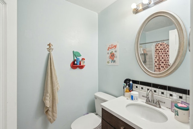 bathroom featuring vanity, toilet, and a shower with curtain